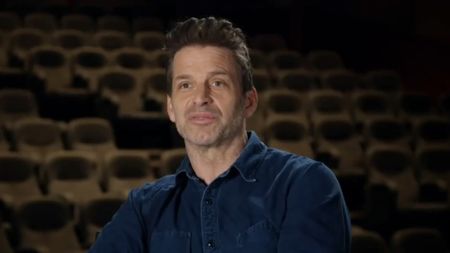 Zack Snyder, dressed in denim button up, sits for an interview discussing the making of his 4 hour vision of the Justice League. 