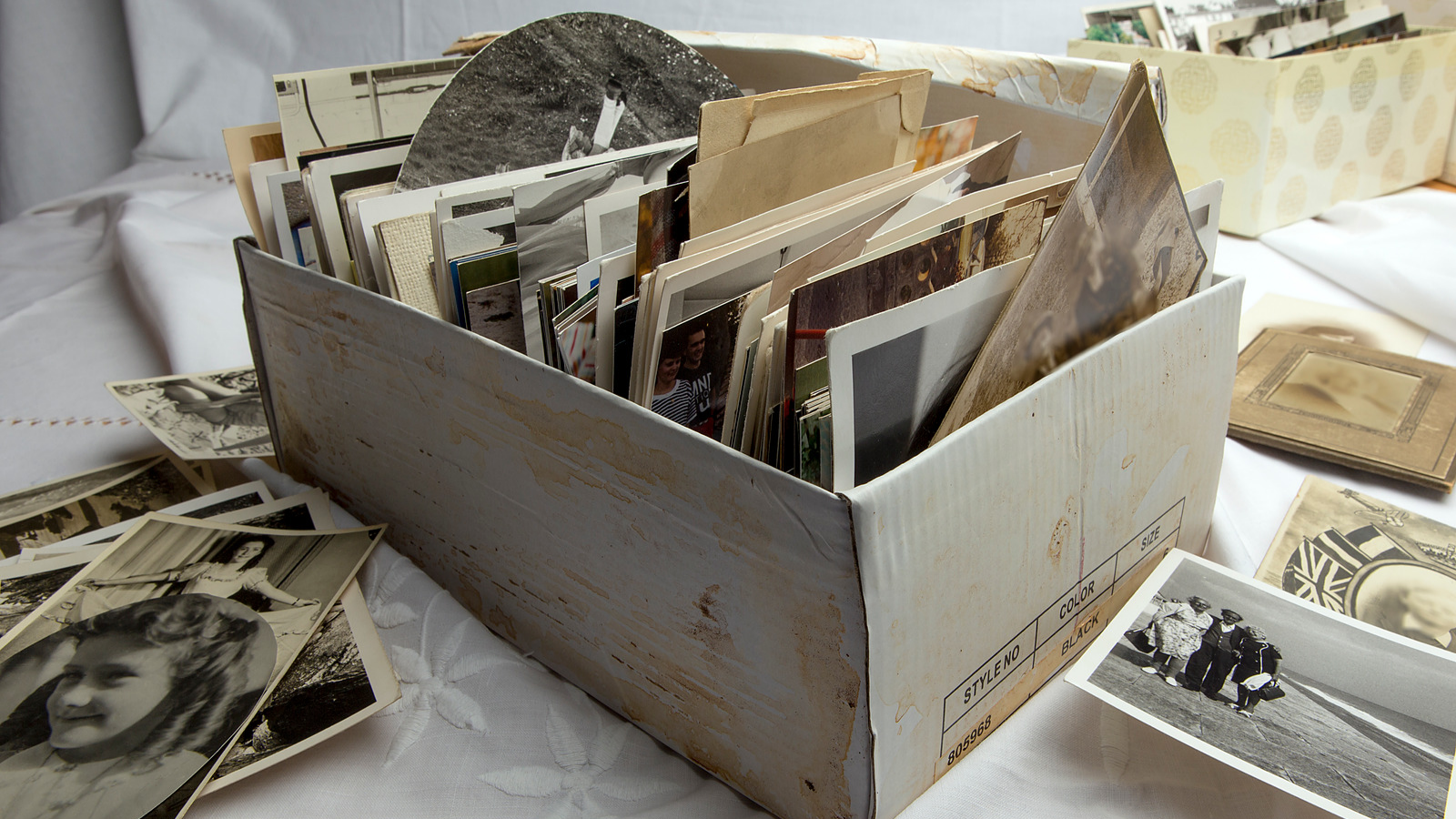 Box of old photographs as part of the process to declutter a bedroom
