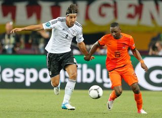 Jetro Willems of the Netherlands and Sami Khedira of Germany battle for the ball at Euro 2012