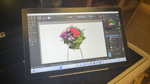 A Huion Kamvas Studio 16 drawing tablet in use on a table