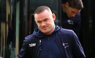 Rooney, in Derby coaching attire, arrives at the ground on the team bus