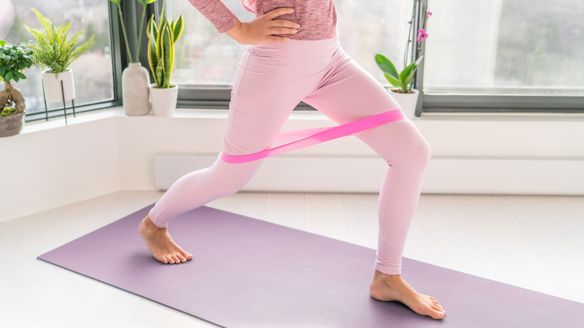 Woman stretching her hamstrings with a resistance band