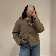 Lauren Tappan wearing a collarless coat and jeans