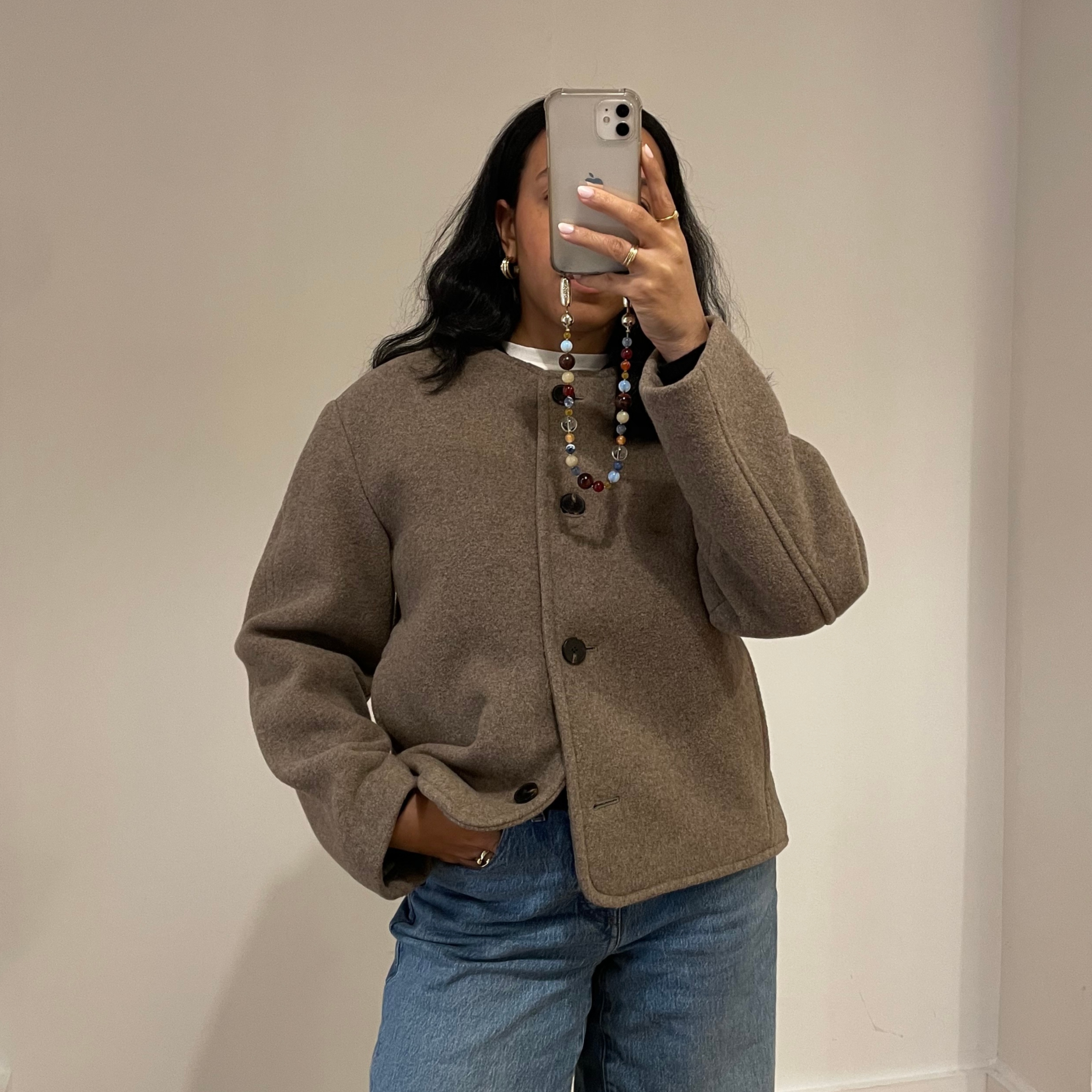 Lauren Tappan wearing a collarless coat and jeans