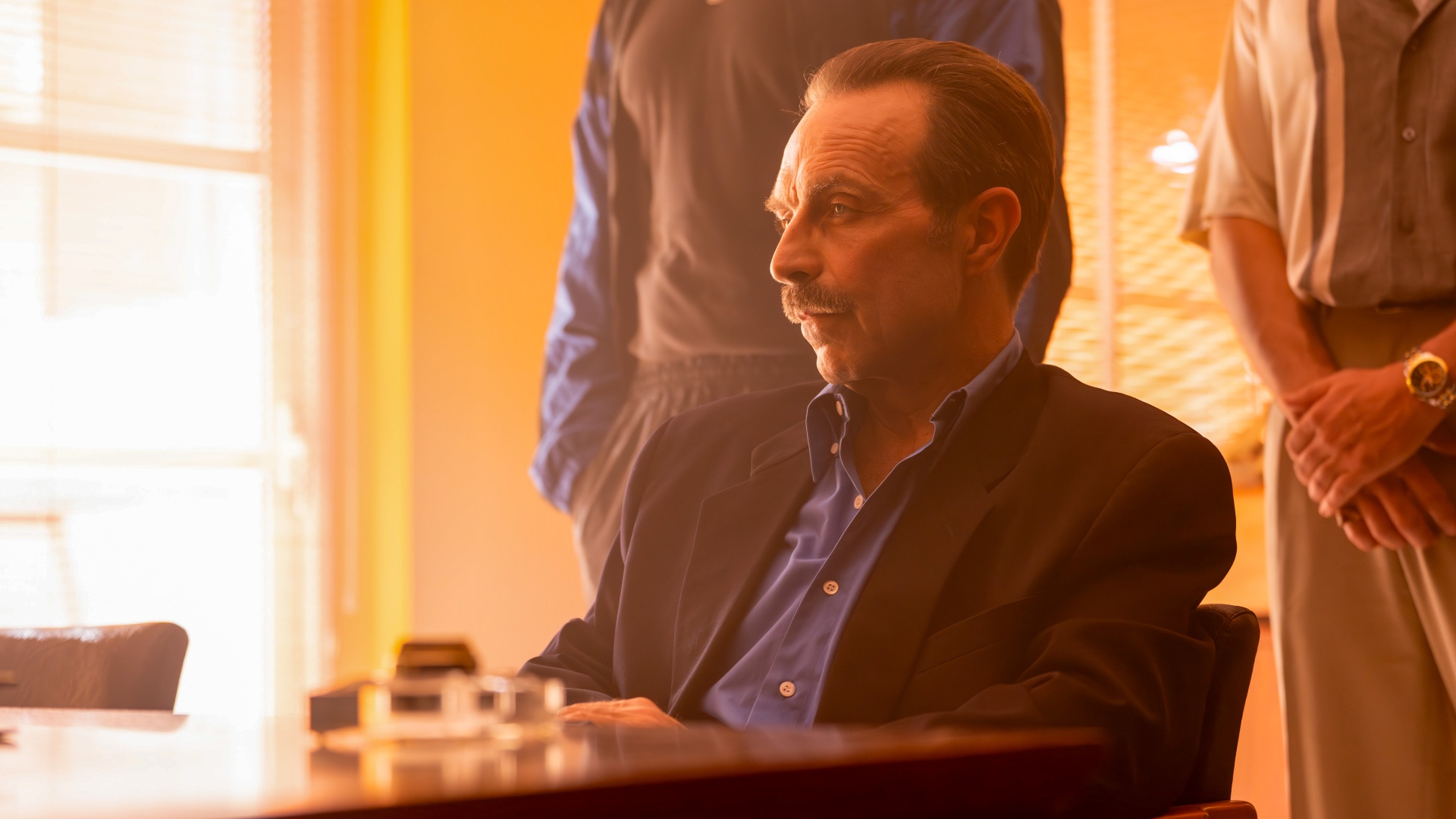 Ivan sits at a desk in The Gold season 2