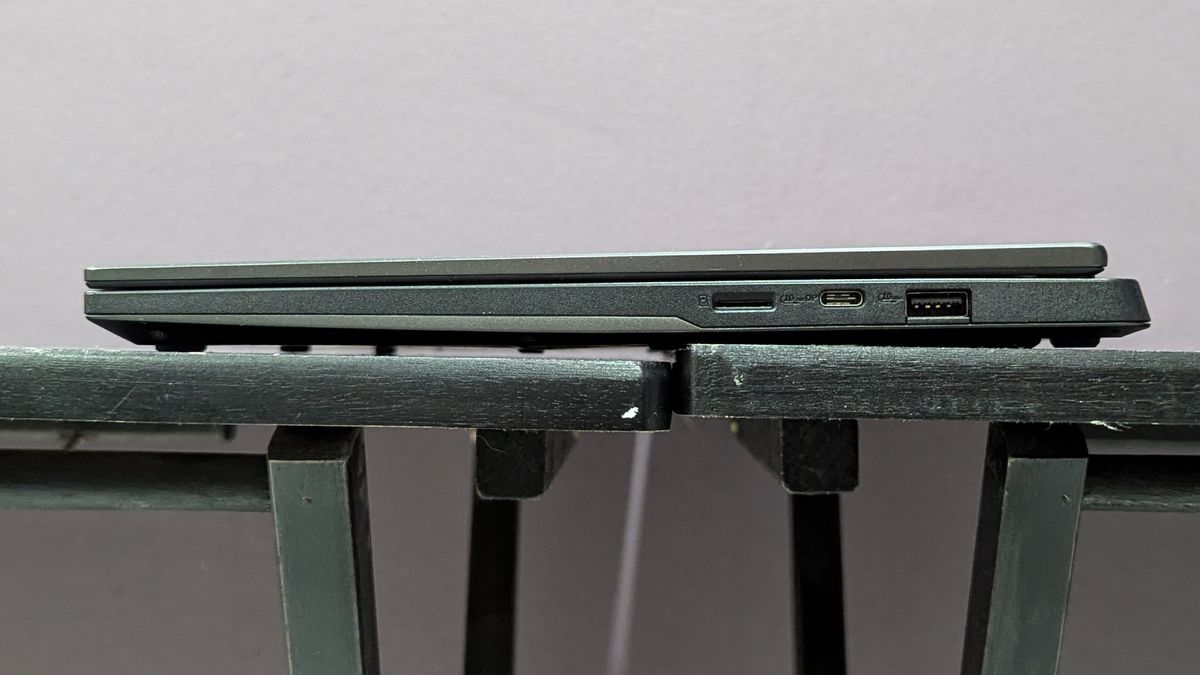 Side view of the Asus TUF Gaming A14 on a black desk showing the ports on the right side.