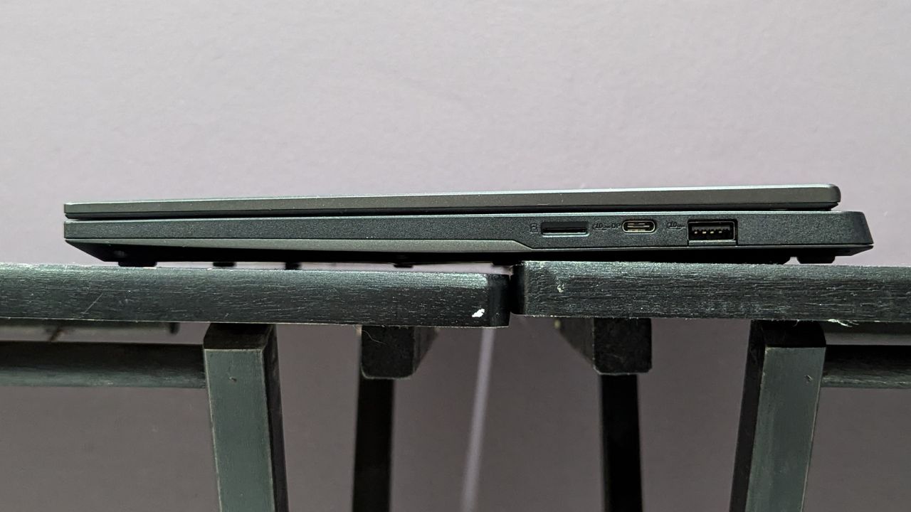 Side view of the Asus TUF Gaming A14 on a black desk showing the ports on the right side.