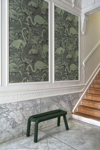 entryway with wallpapered panels, marble floor