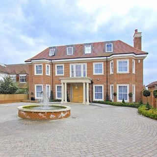 sloping roof house with chimney stack and water fountain