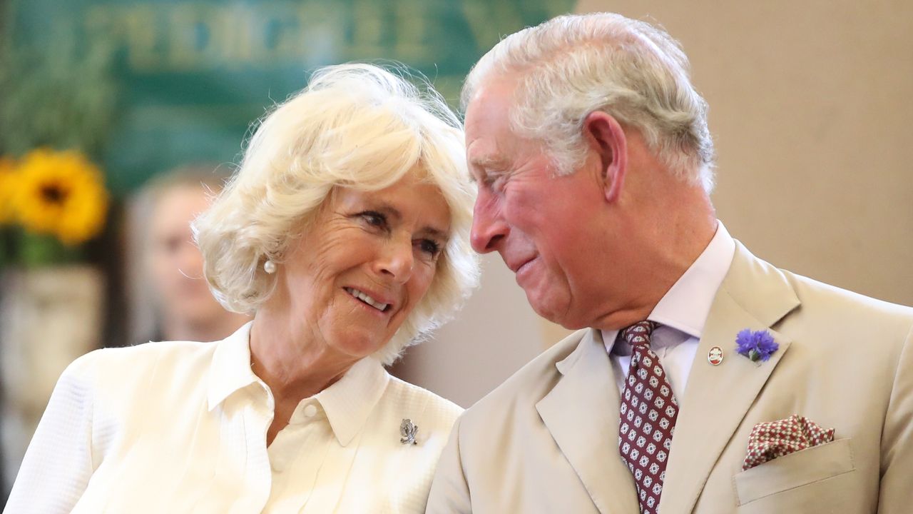 Queen Camilla&#039;s Valentine&#039;s Day moments with King Charles 2023 explained. Seen here looking at each other as they reopen the newly-renovated Edwardian community hall The Strand Hall 