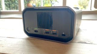 A SanDisk Professional Pro-Blade Station sitting on a wooden desk