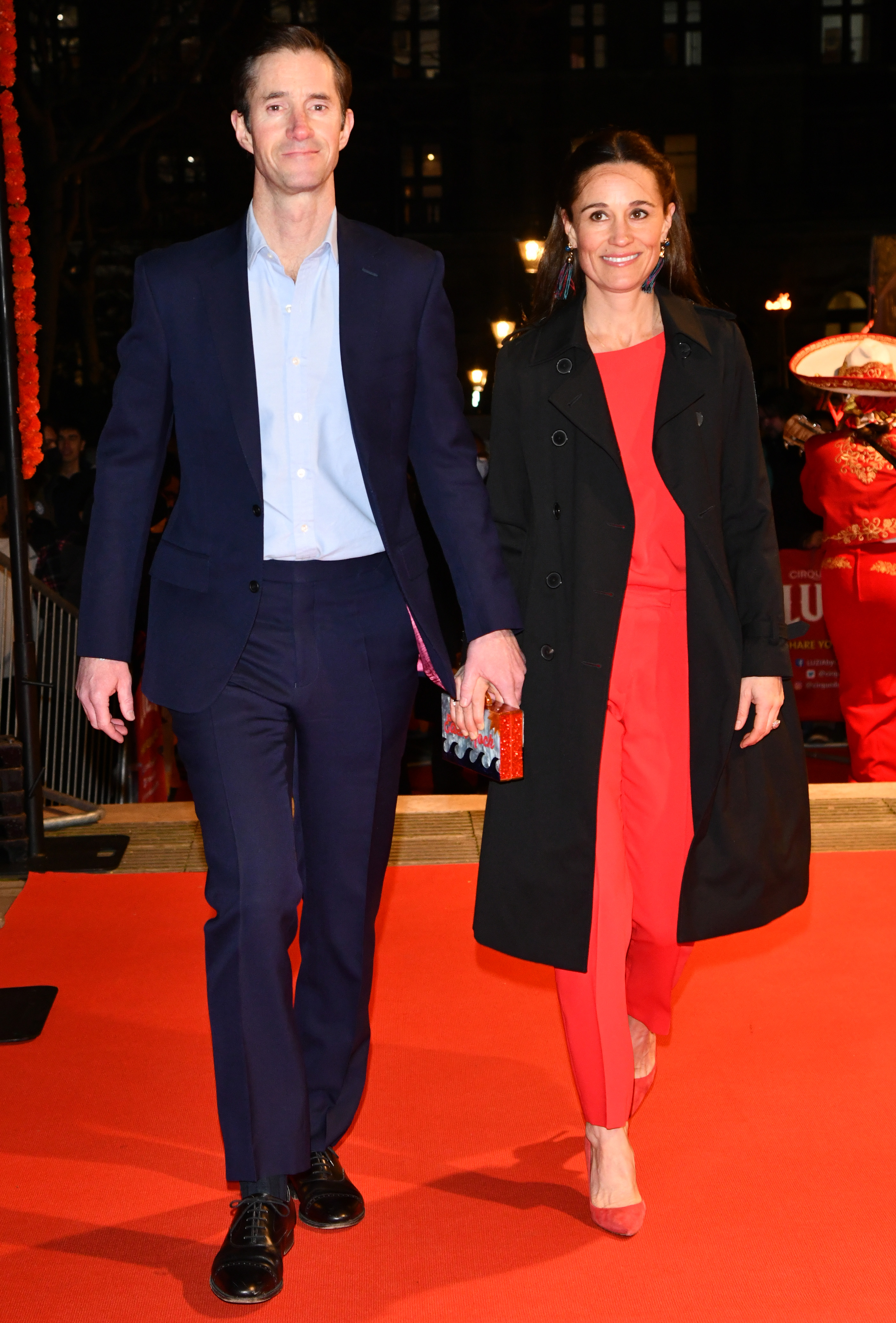 Pippa Middleton and James Matthews walking on a red carpet