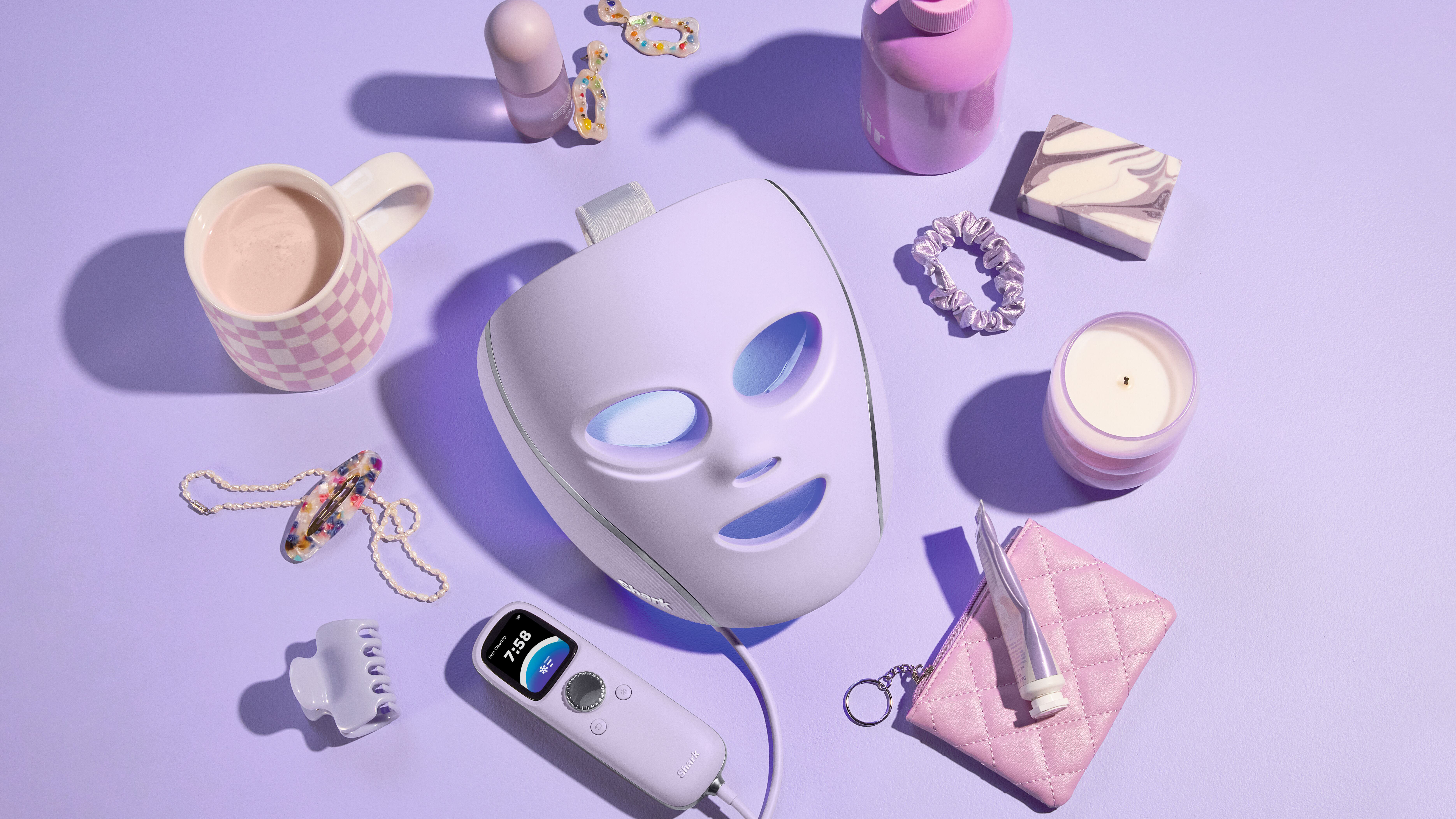 Shark Beauty CryoGlow mask with purple background and purple products