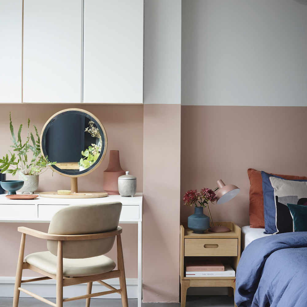 room with wooden chair mirror and table lamp