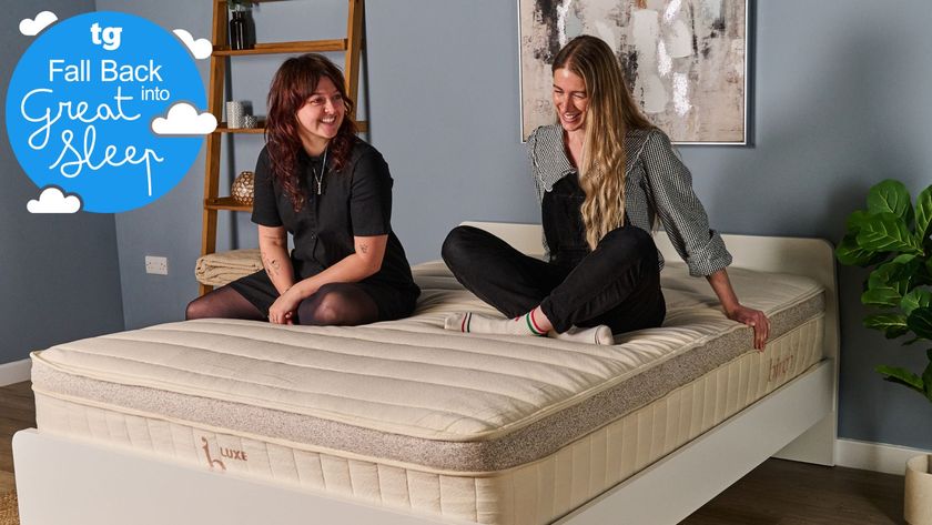 Two Tom&#039;s Guide testers sitting on the Birch Luxe mattress smiling and laughing