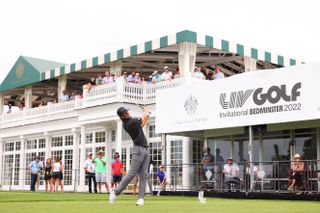 Turk Pettit hits a shot in front of a LIV Golf banner