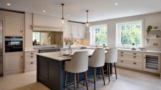 a neutral kitchen with an island and pendant lighting