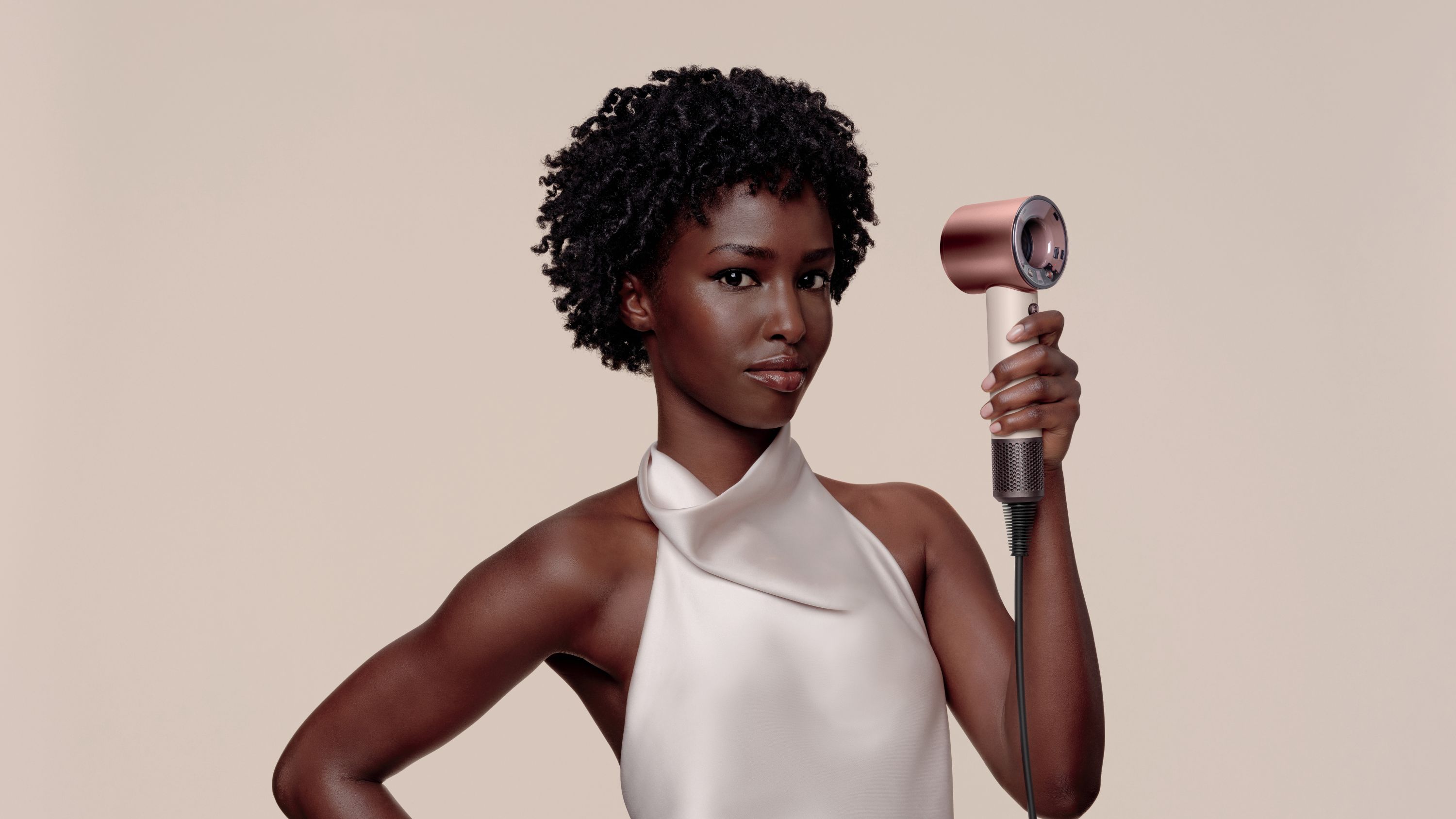 Woman holding Dyson Supersonic Travel hair dryer