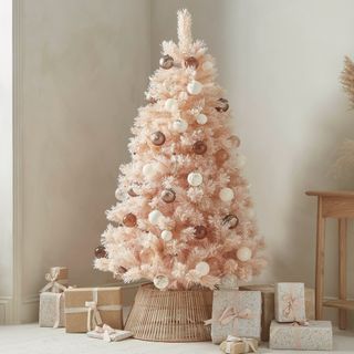 Cox & Cox Dusky Blush tree with presents underneath it, against a beige wall