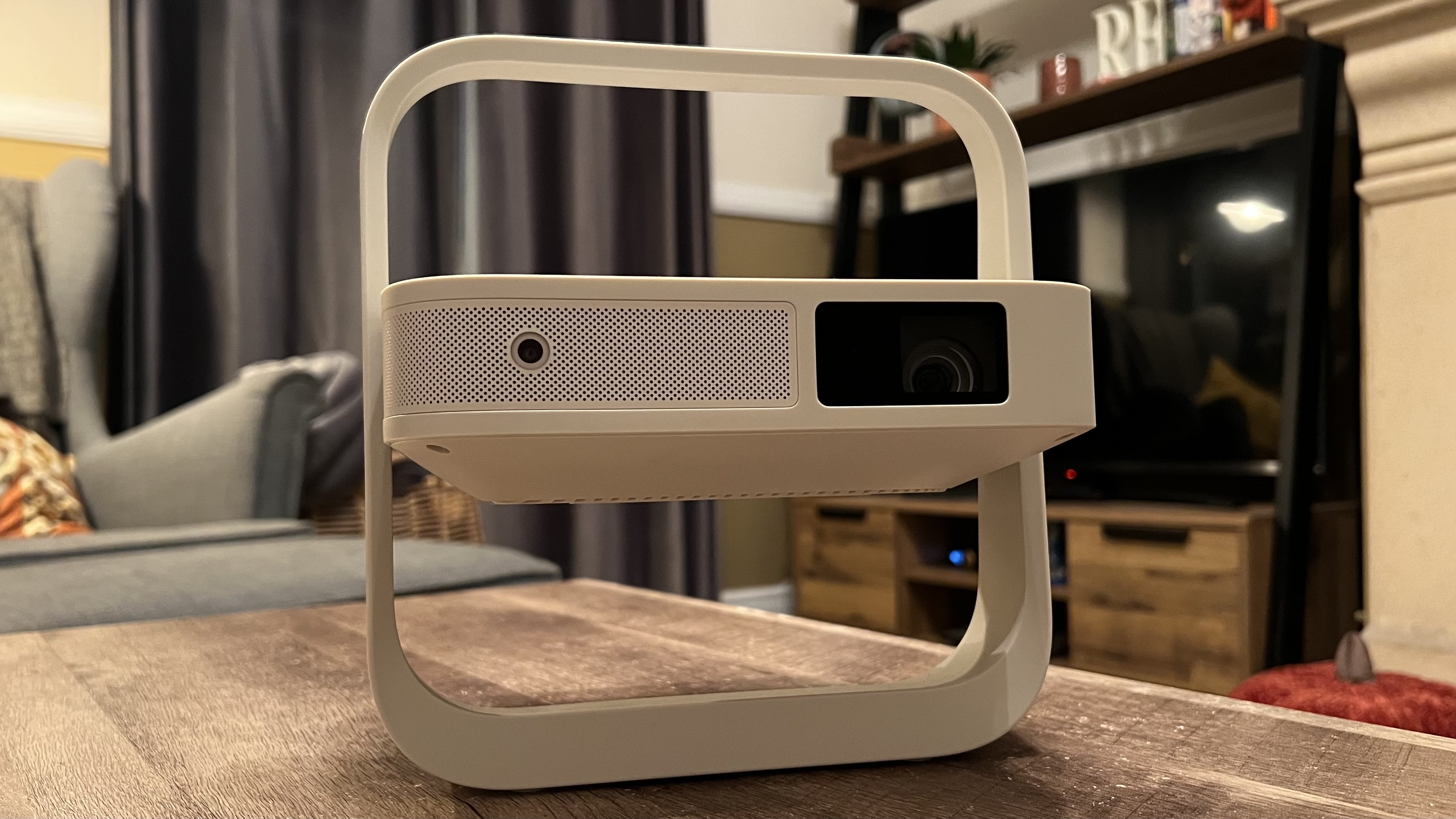 XGIMI Elfin Flip projector on a coffee table with an LG TV in the background
