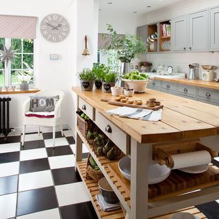 kitchen room with wooden worktop and black and white tiles floor