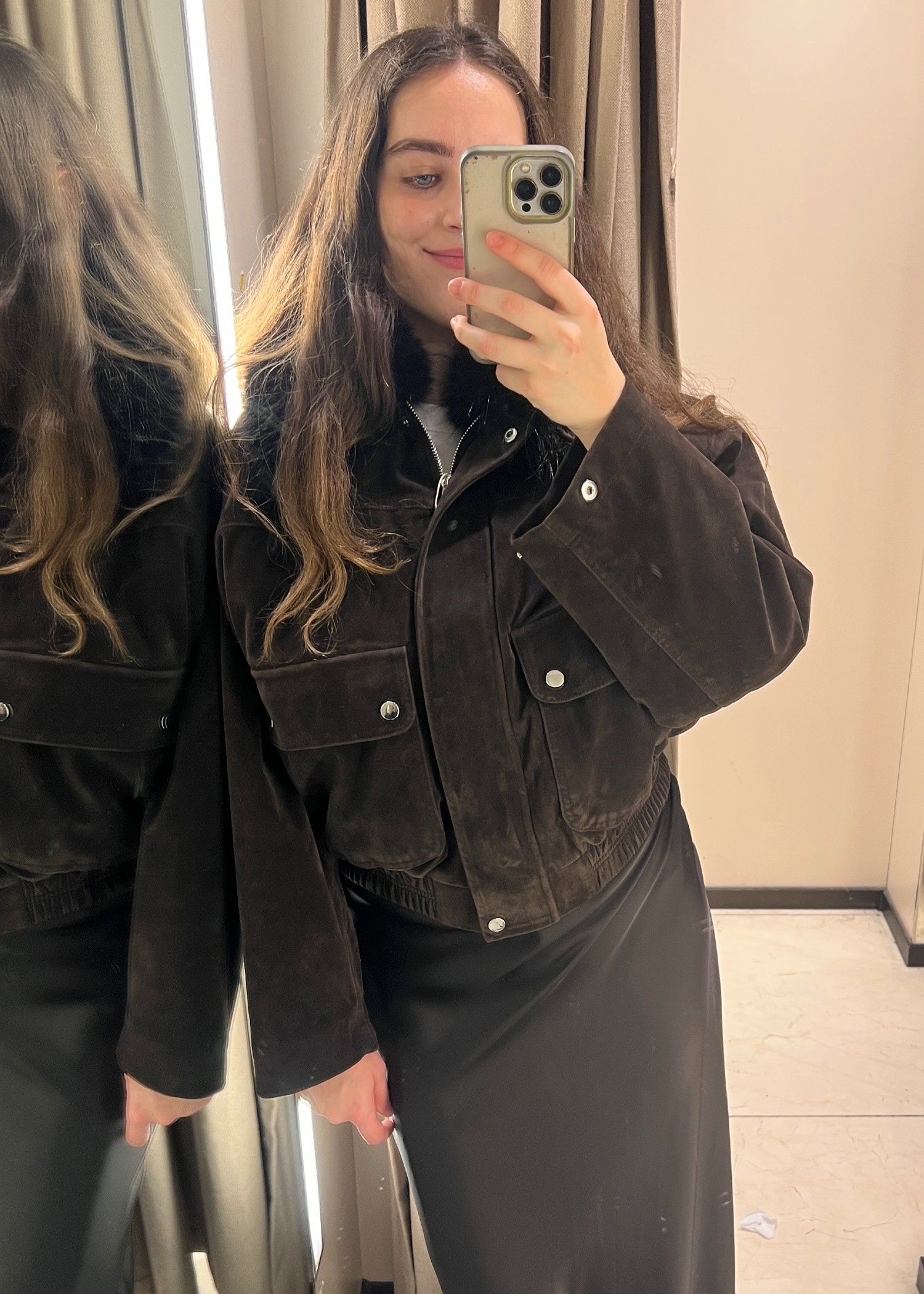 An image of Who What Wear UK's SEO Writer Ava Gilchrist wearing a satin skirt from Zara with a fur-trimmed suede bomber jacket.