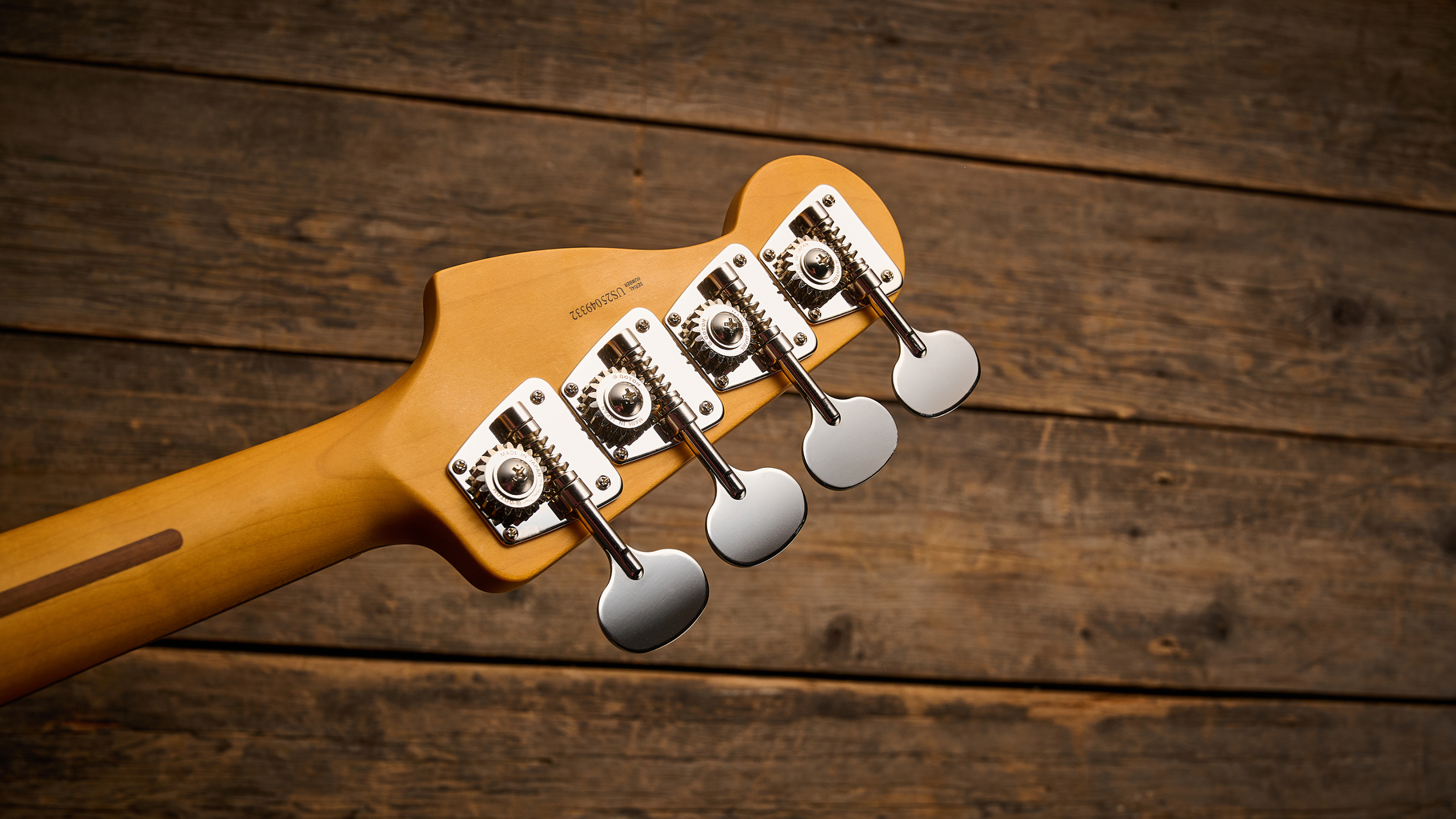 Fender American Professional Classic Precision Bass in 3-Color Sunburst shot on wood floor boards