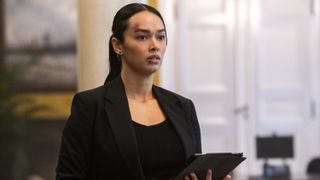 Vinessa Vidotto as Special Agent Cameron Vo holding a tablet in FBI: International season 3