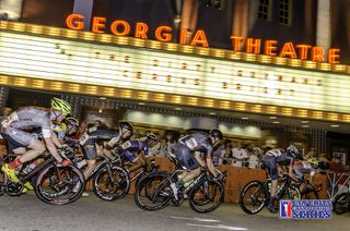 The men's peloton speed by the Georgia Theatre at Athens Twilight Criterium