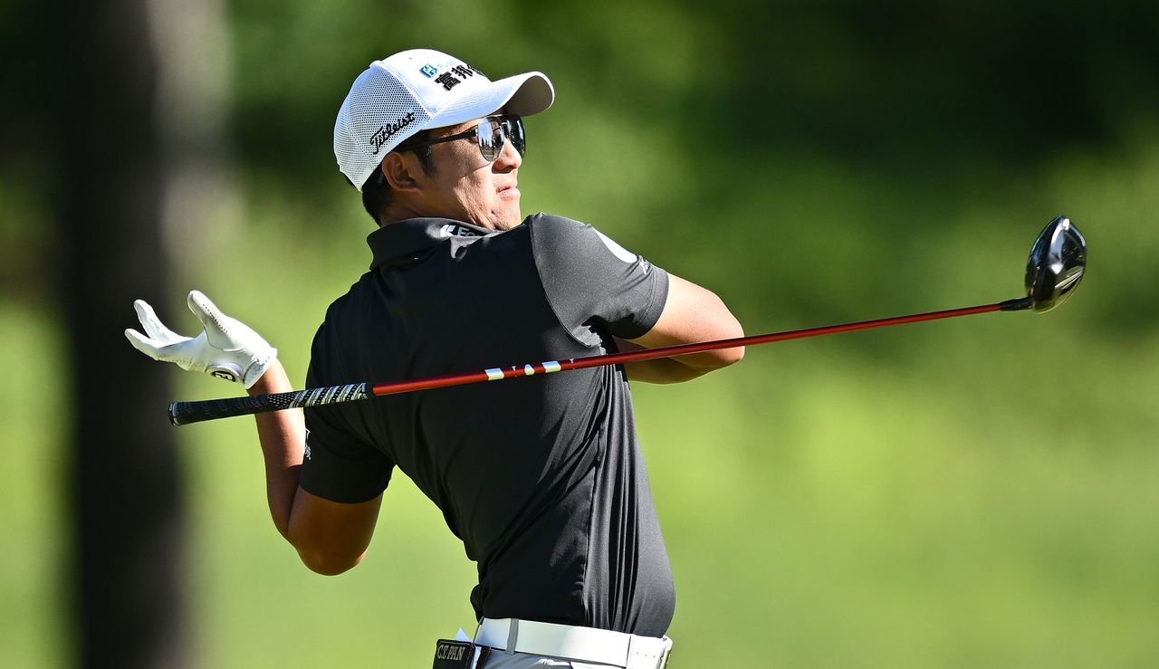 C.T. Pan drops his golf club after a wayward tee shot