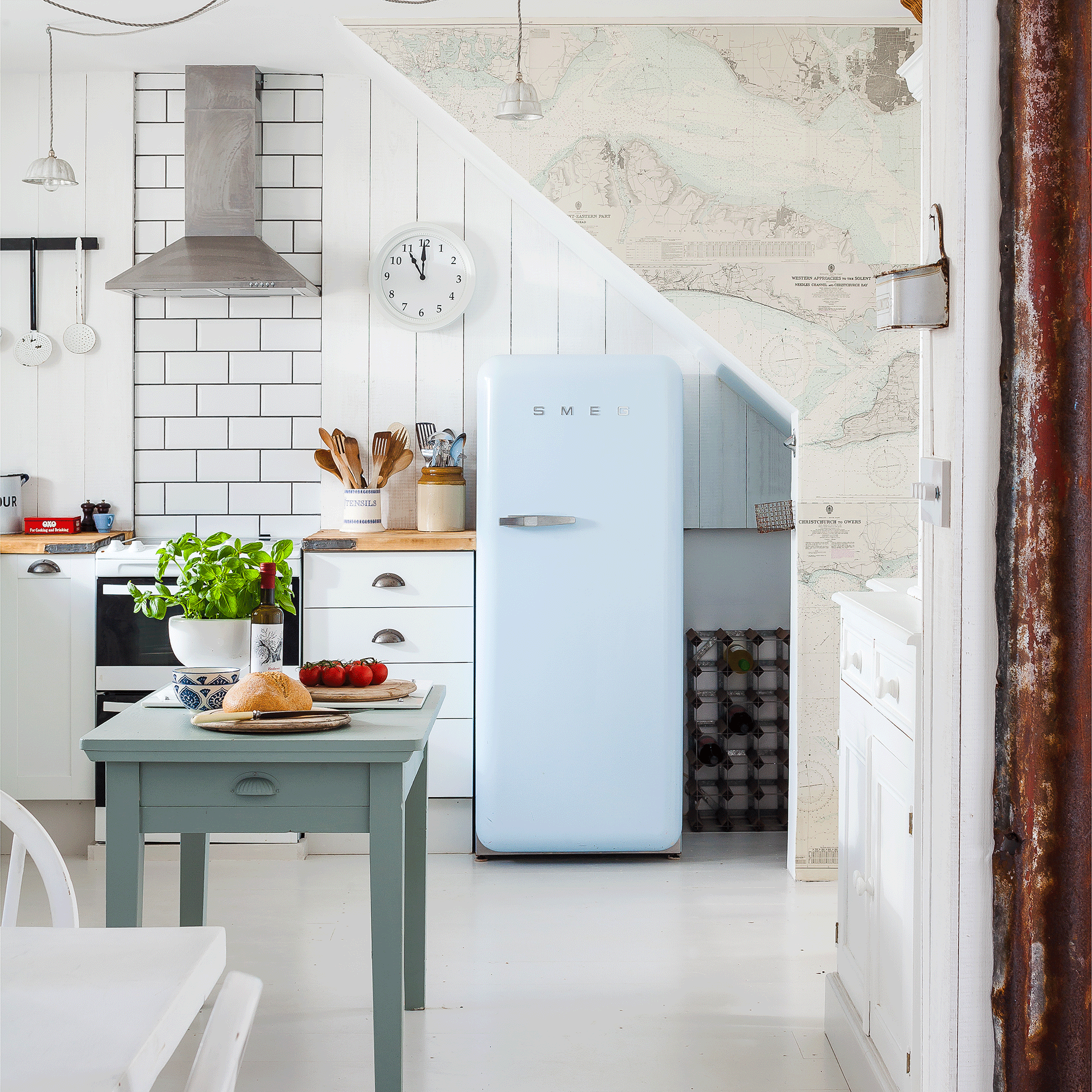 Blue fridge freezer in a white kitchen