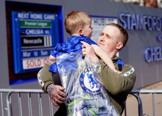 Martyn Hardiman with his son Peter, two, after purchasing the last Chelsea shirt before the store at Stamford Bridge closed on Thursday
