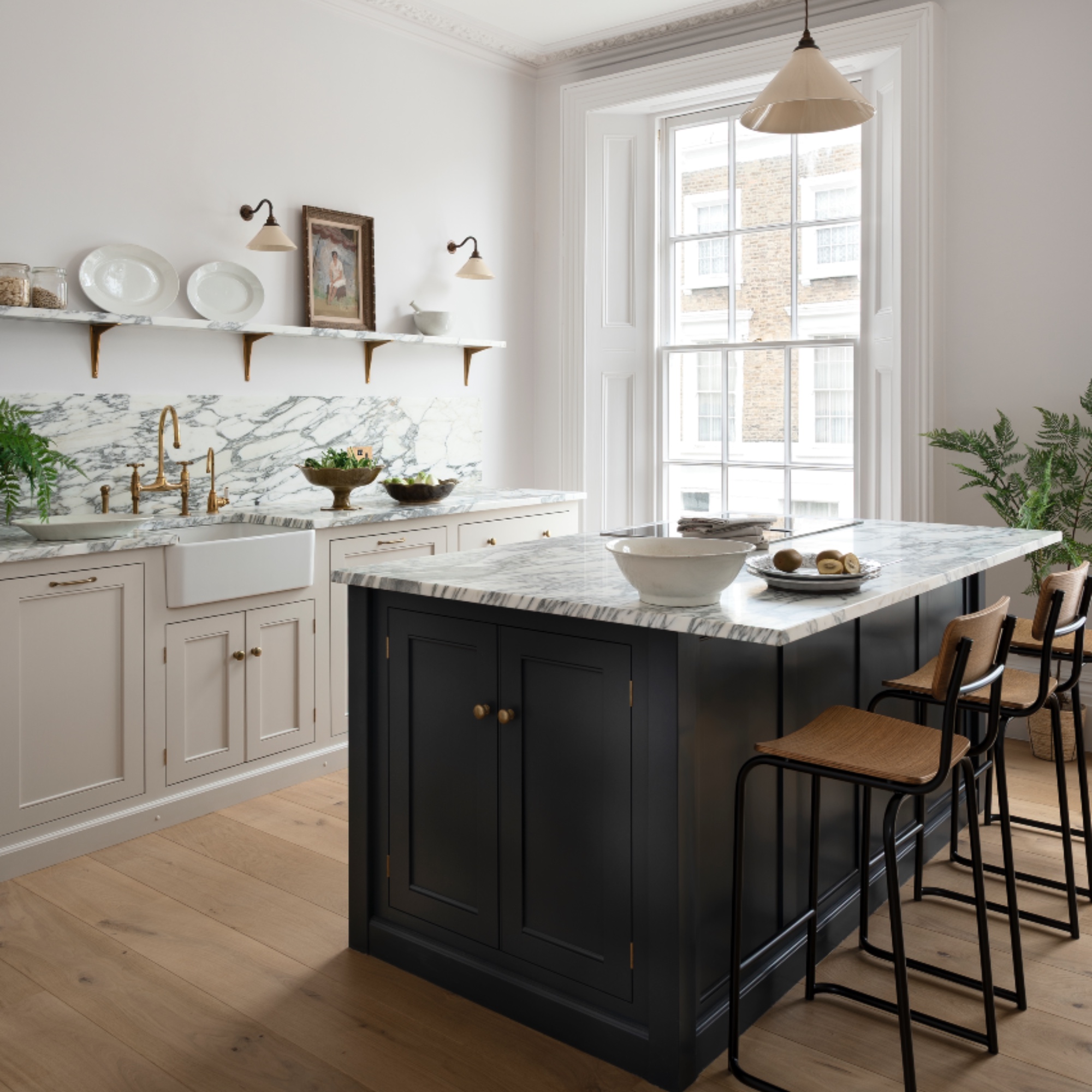 marble and white kitchen with marble work tops, kitchen island with bar stools