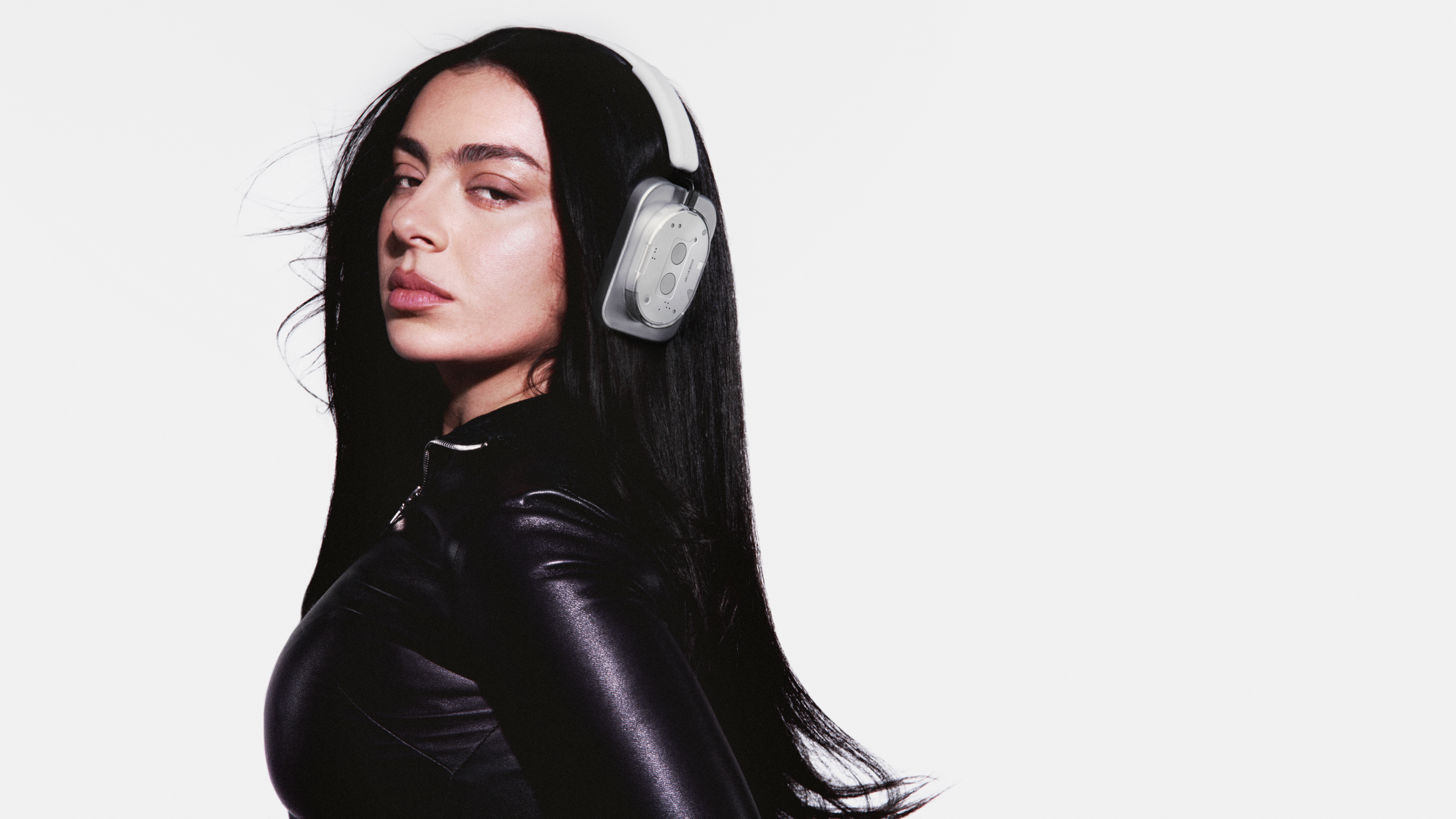 Charli xcx with Nothing phones and headphones