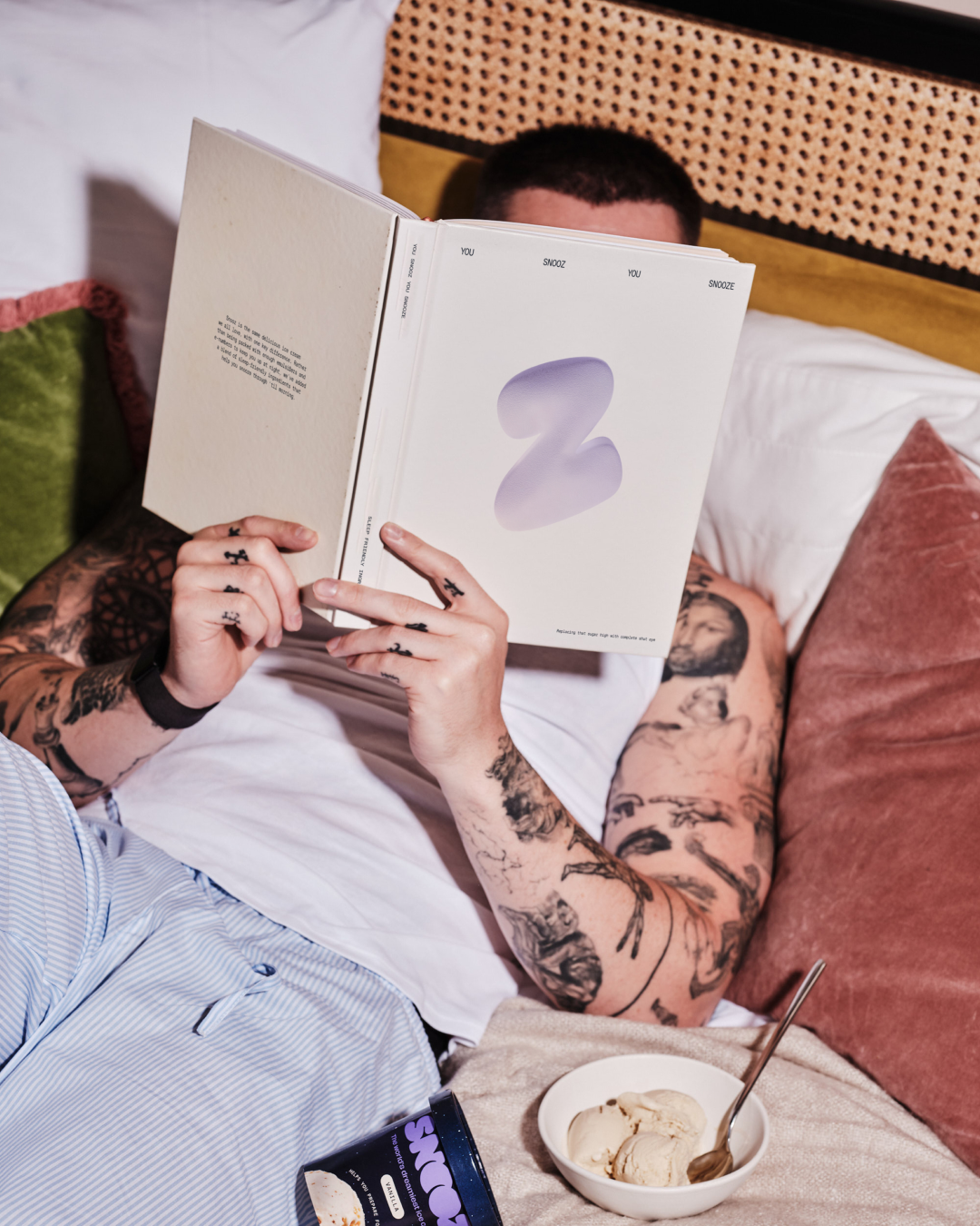 man eating ice cream before bed reading a book