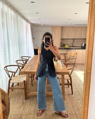 woman in navy vest and jeans