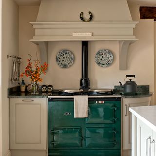 kitchen with green cooker and white cabinets