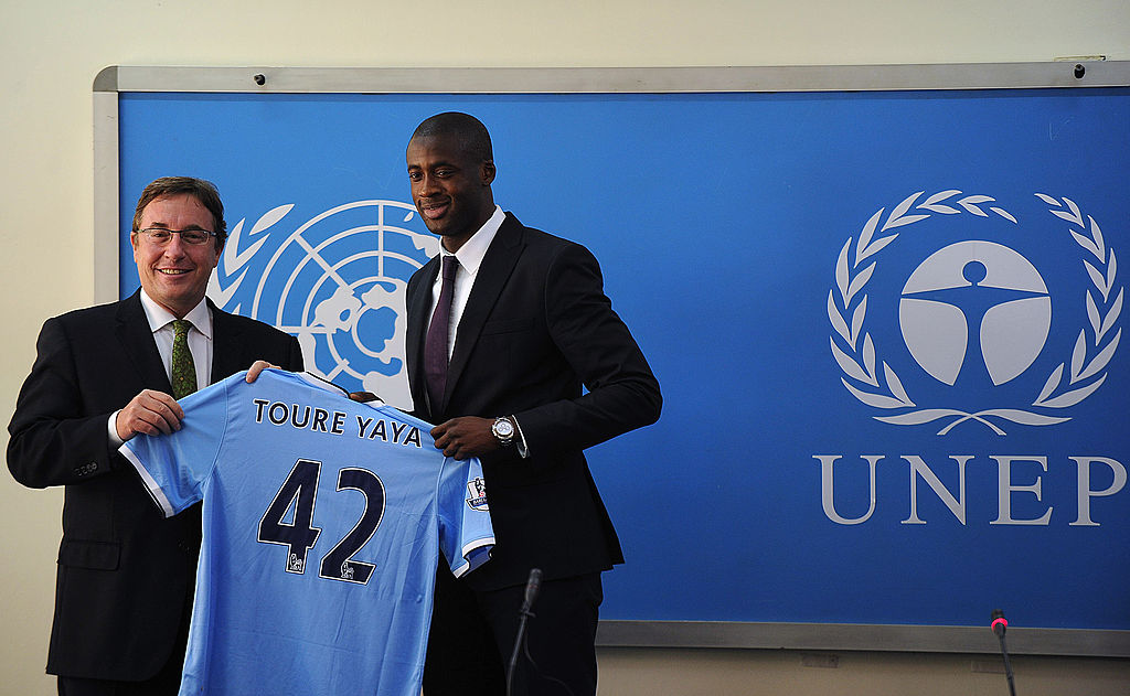 Ivory Coast's football player Yaya Toure (R) gives UNEP executive Director Achim Steiner a signed Manchester City jersey as he was appointed the United Nations Environment Program goodwill ambassador during a press conference at the UNEP headquarters in the Kenyan capital Nairobi on October 29, 2013. Toure, African Footballer of the Year Toure and star of Manchester City, warned that the slaughter of elephants for their ivory was threatening their very existence as he was appointed UNEP ambassador.