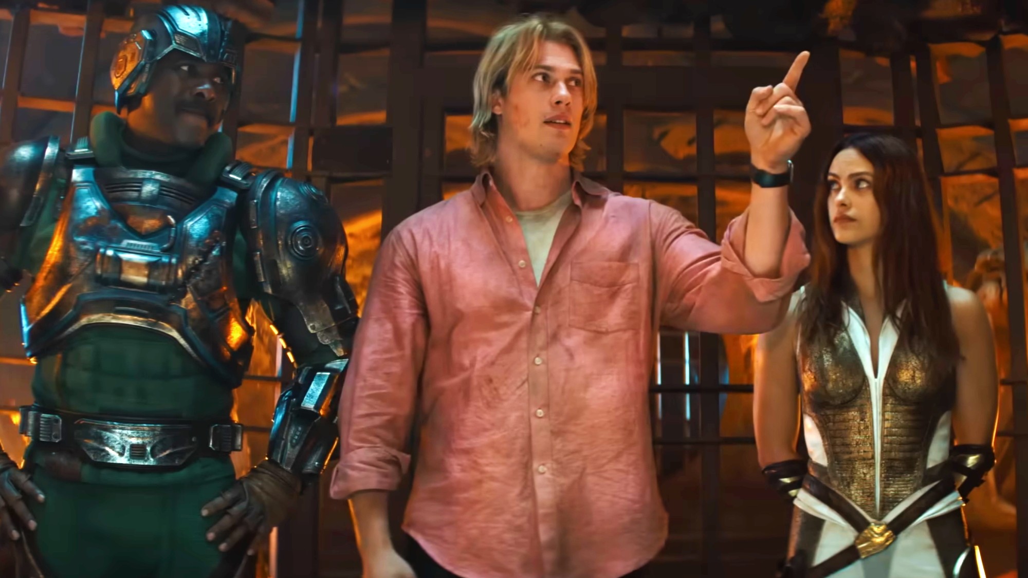 Man at Arms standing with Adam and Teela in Masters of the Universe, with Adam pointing to their left.