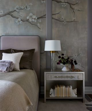 bedroom with floral wall mural, lilac headboard and cozy decor