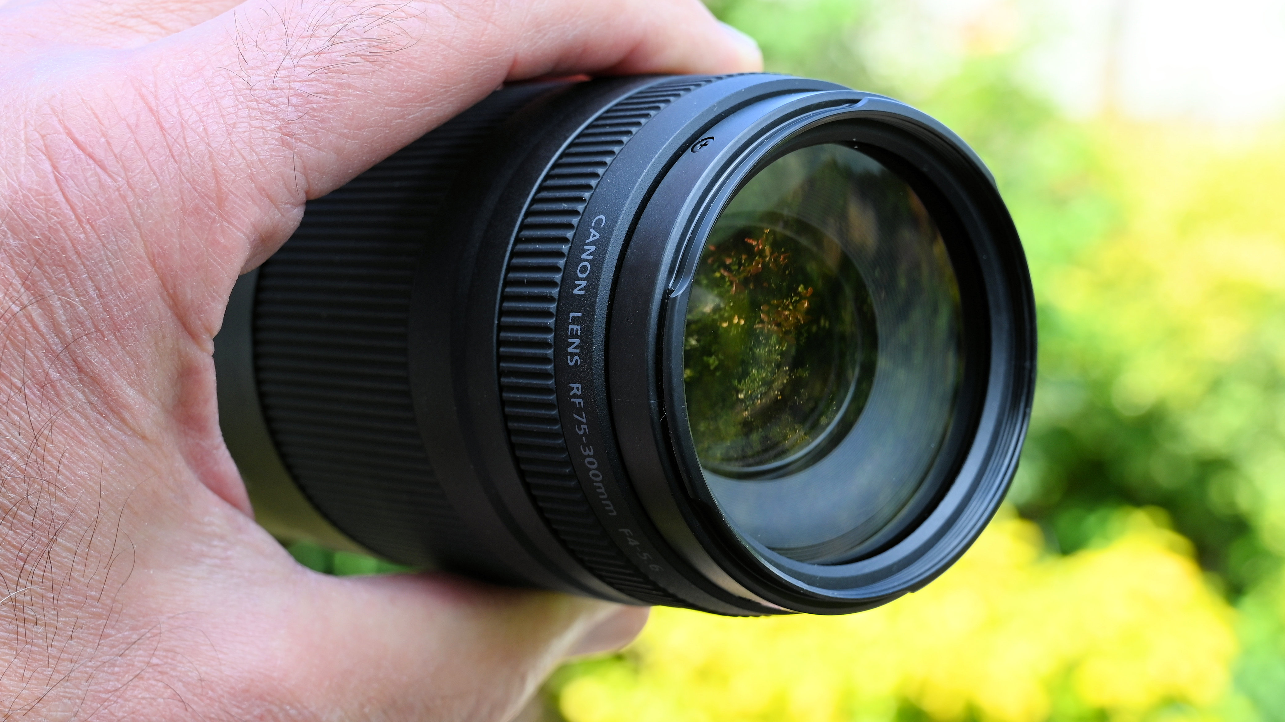 Canon RF 75-300mm f/4-5.6 product shot held in hand