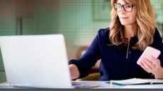 A whitepaper from Zscaler on architecting enterprise networks with female worker at a laptop