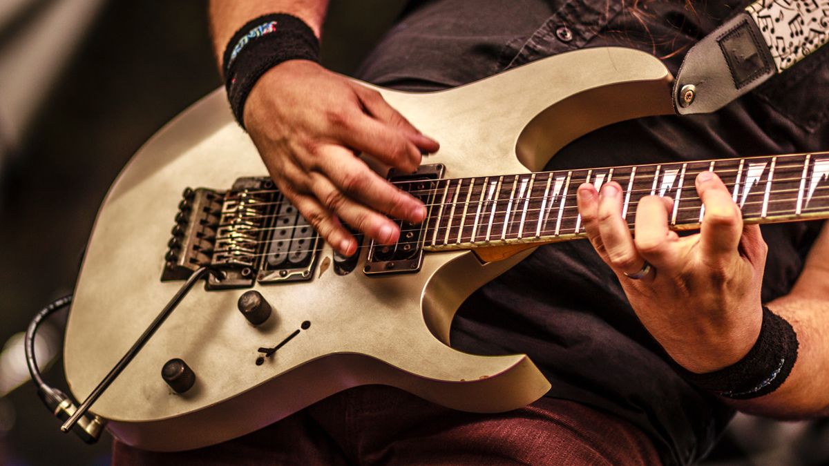 Midsection Of Man Playing Guitar During Concert