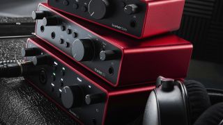 Three Focusrite Scarlett audio interfaces stacked on top of one another