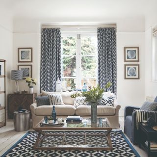 A living room with glass doors and matching patterned curtains and rug