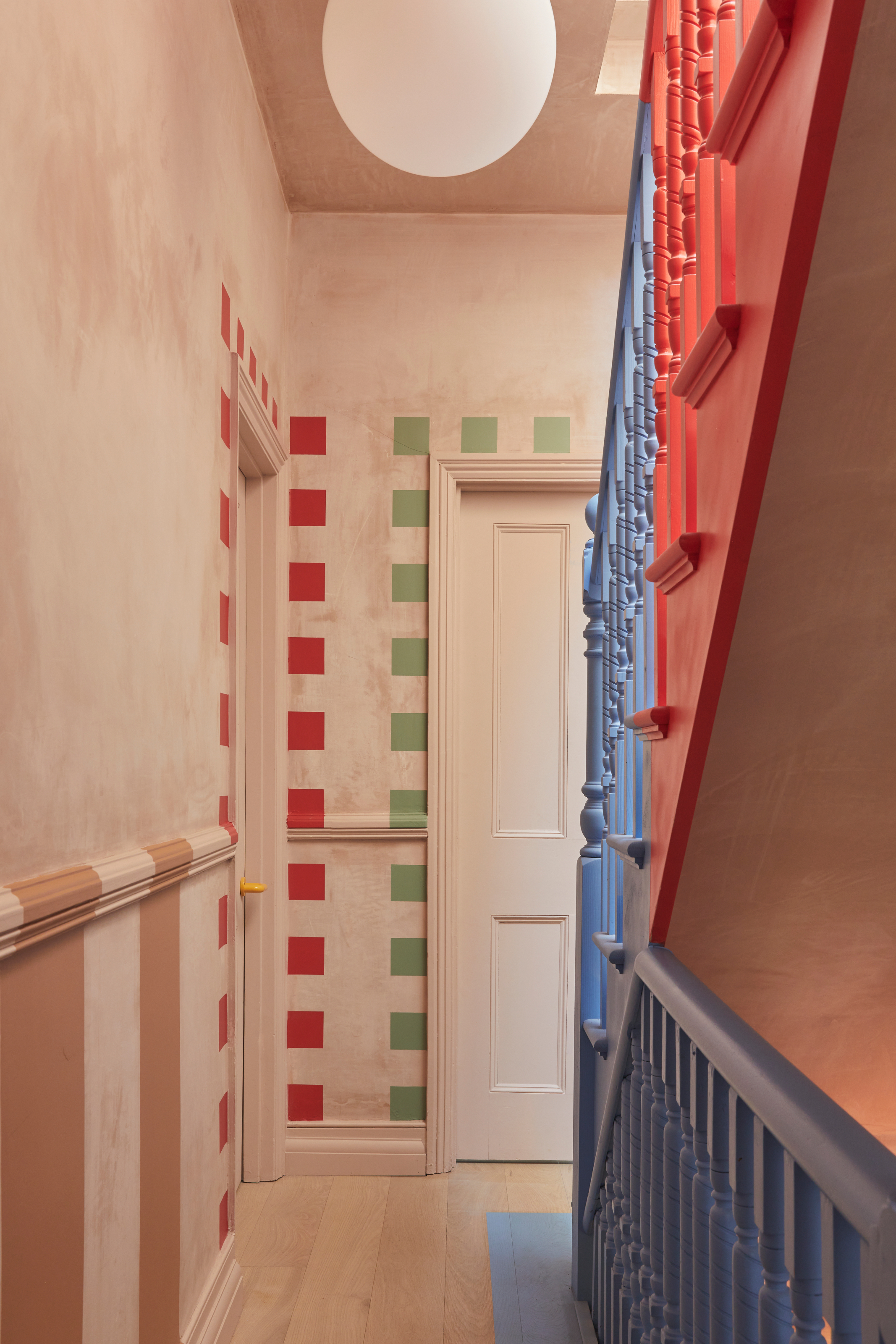 Hallway with door framed by green and red squares