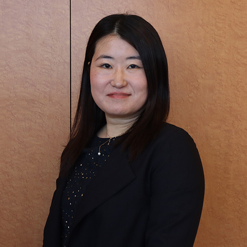A smiling woman with long black hair 