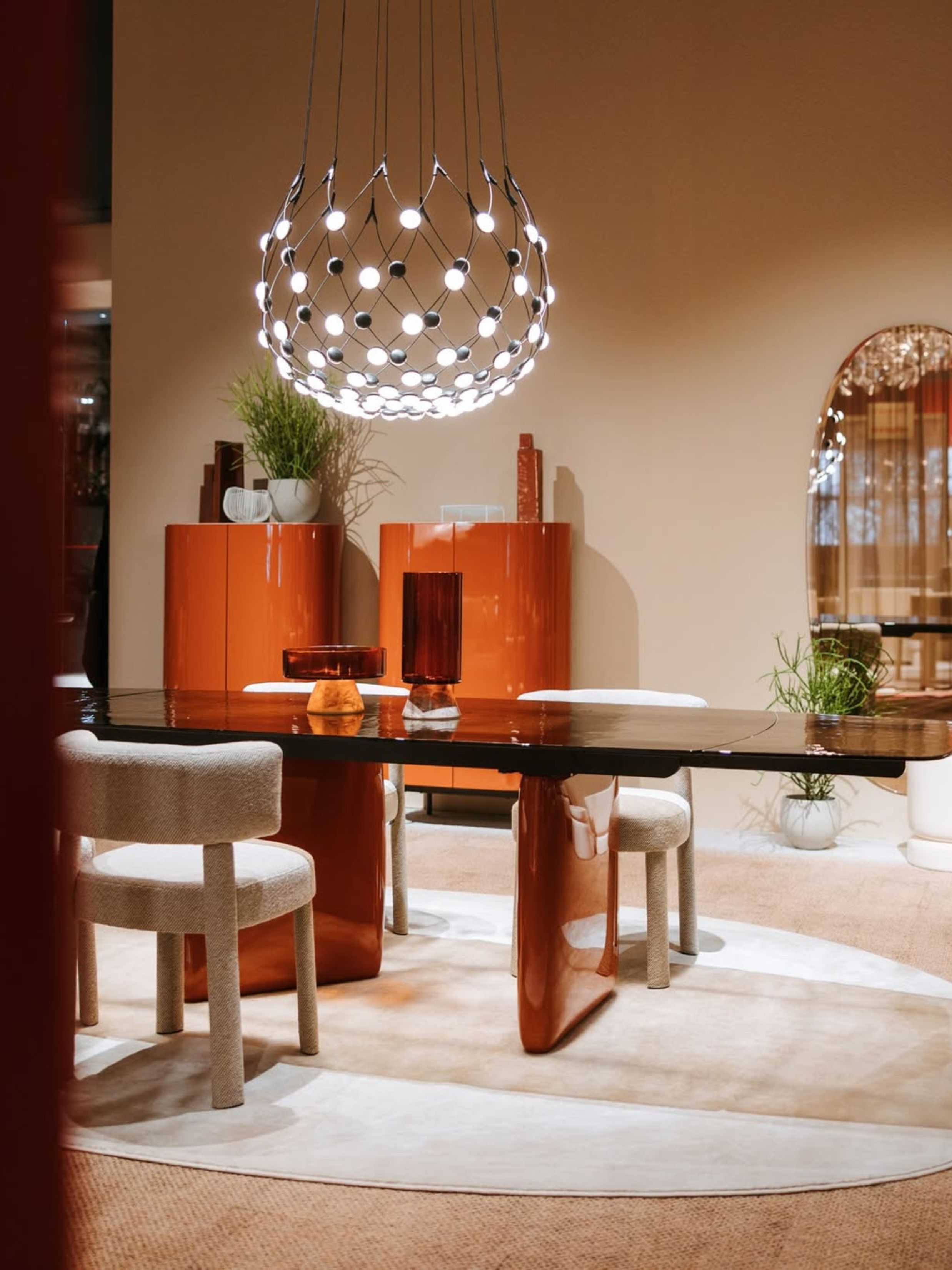 a table with a red lacquer base in a showroom with a lacquer cabinet behind