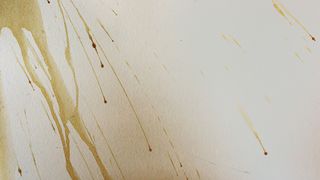 coffee stains spilled on a white wall
