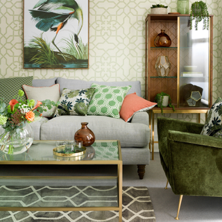 Green and gold glass coffee table with vase and fresh flowers